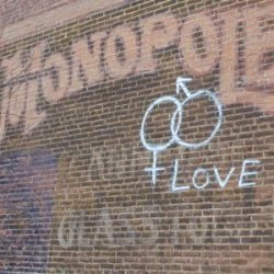 Photo of an ad on the west side of the Crosfield Building featured Monopole, THE BEST CANNED & GLASS FOODS.